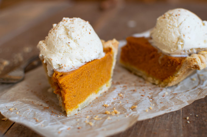 slice of pumpkin pie with scoop of homemade cinnamon ice cream on top