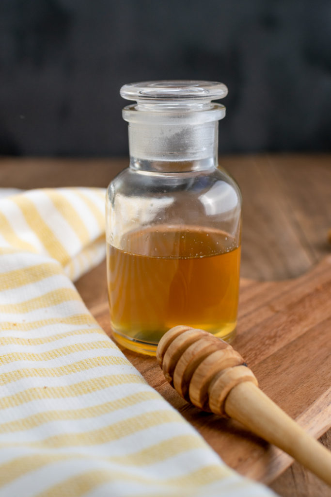 jar of honey simple syrup and honey dipper