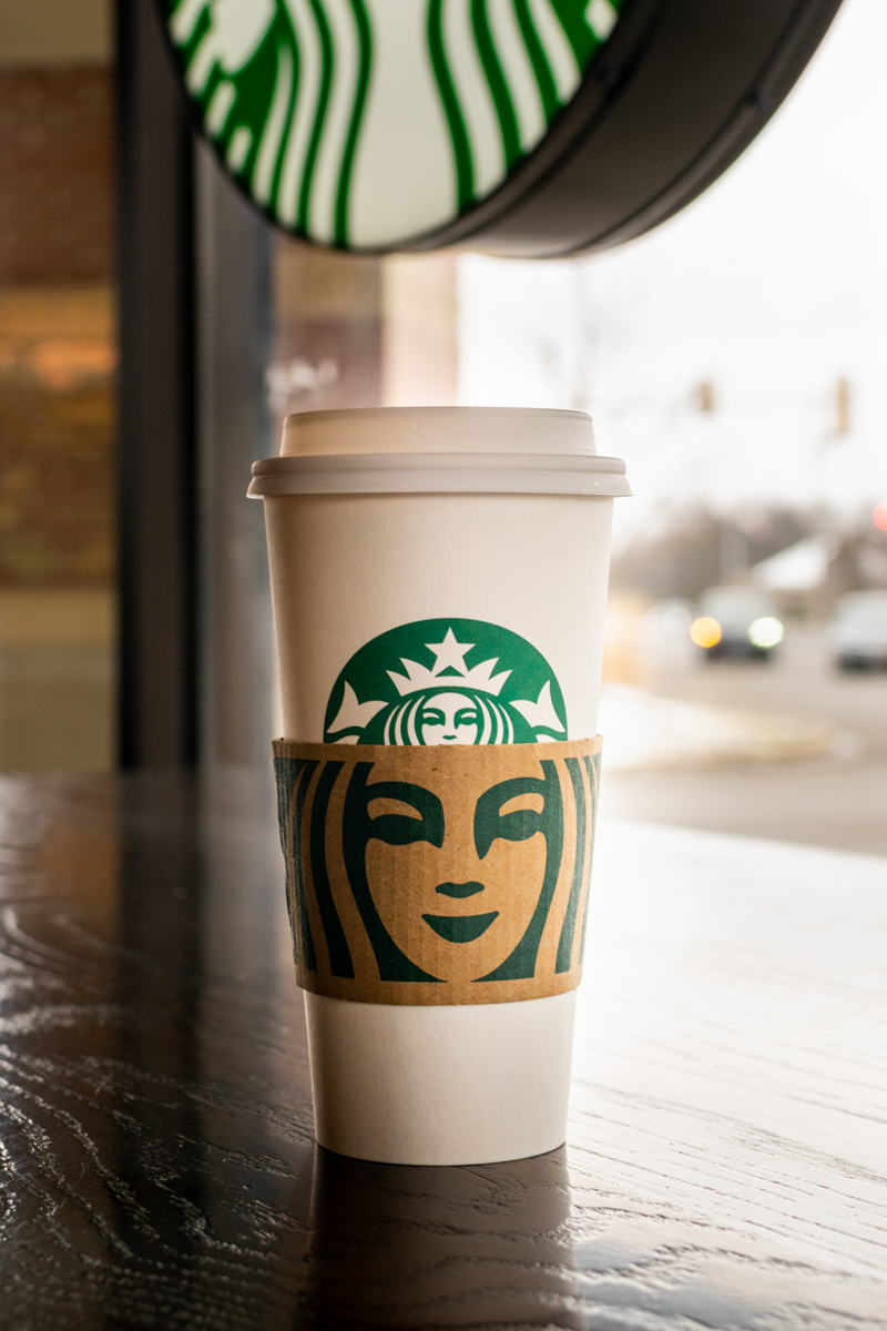 starbucks hot tea inside cafe under logo