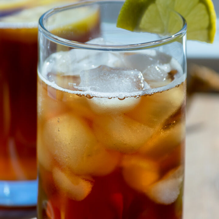 lemon iced tea in glass with lemon wedge