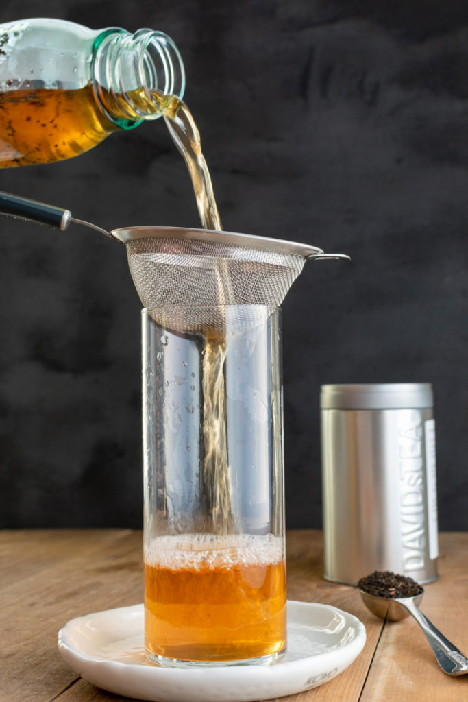 Pouring cold brew tea through strainer