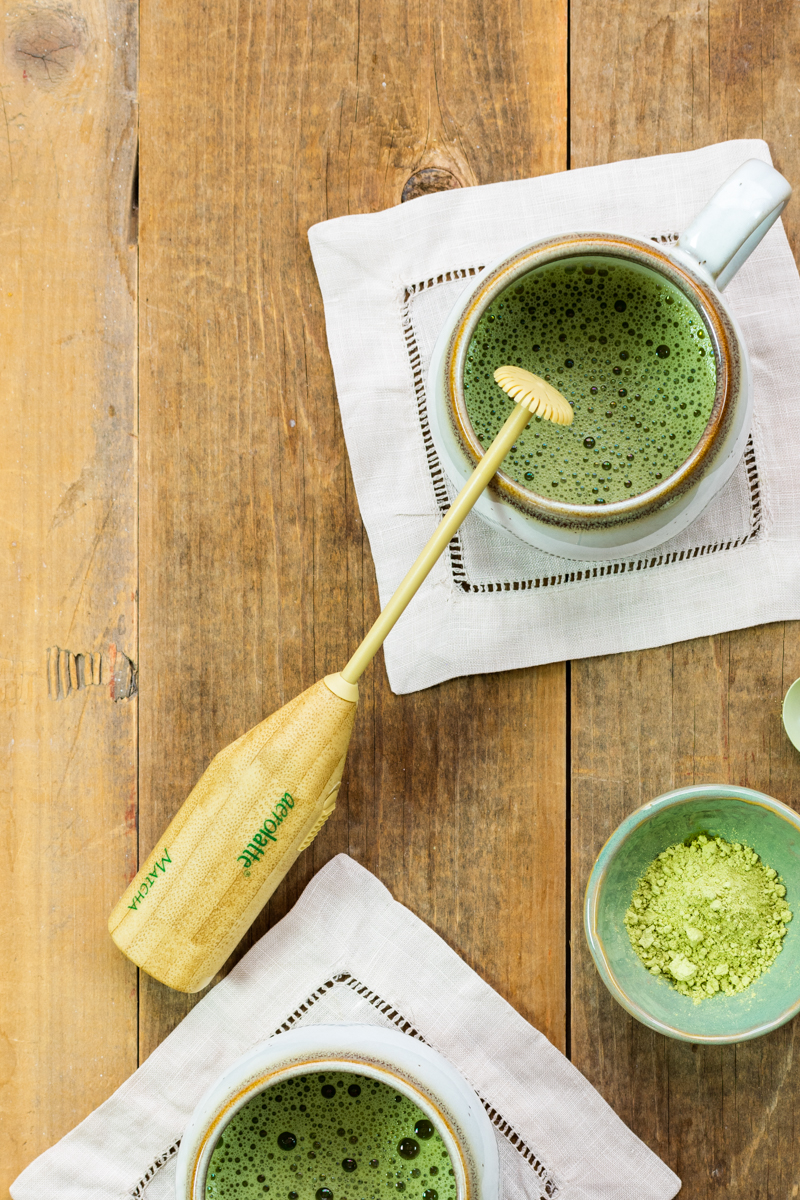 matcha mixed with hot water with handheld matcha frother wand