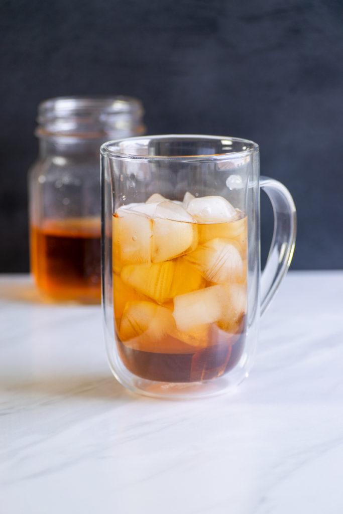cold brew earl grey tea concentrate in glass with ice