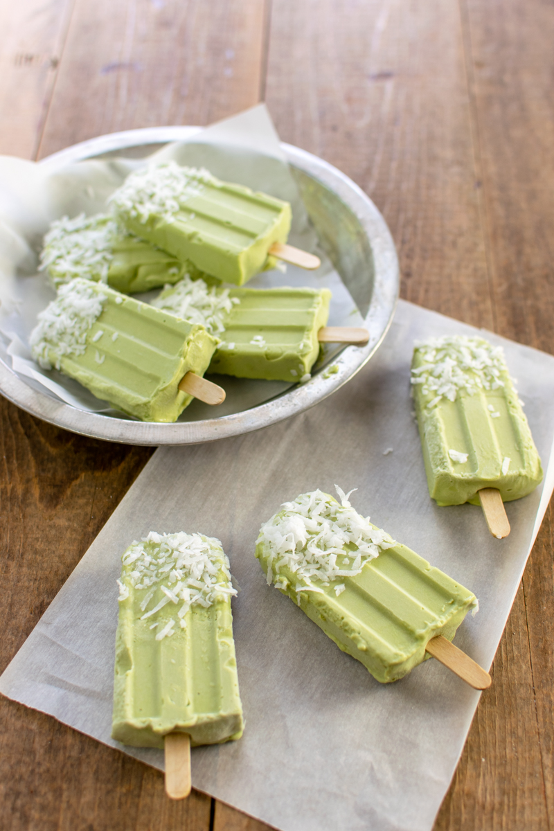 creamy coconut popsicles with matcha and coconut flakes