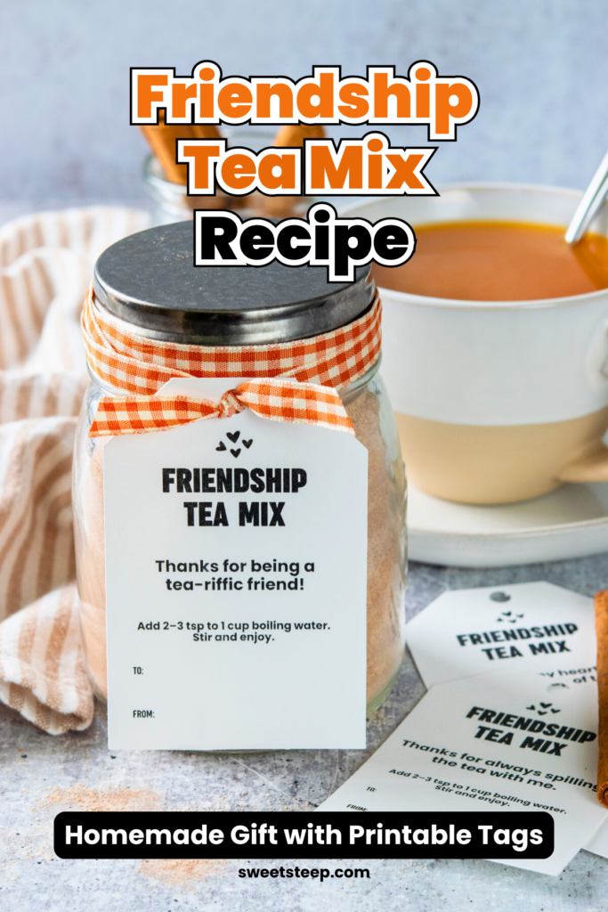 A mason jar of friendship tea mix decorated with ribbon and a gift tag that reads, "Friendship Tea Mix. Thanks for being a tea-riffic friend." Behind the gift is a cup of the steaming hot orange spiced tea ready to drink. Next to the gift jar, are more gift tags. The image has text overlay that reads, "Friendship Tea Mix Recipe. Homemade gift with printable tags."