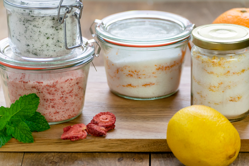 jars of flavor infused sugar - mint, strawberry, orange and lemon