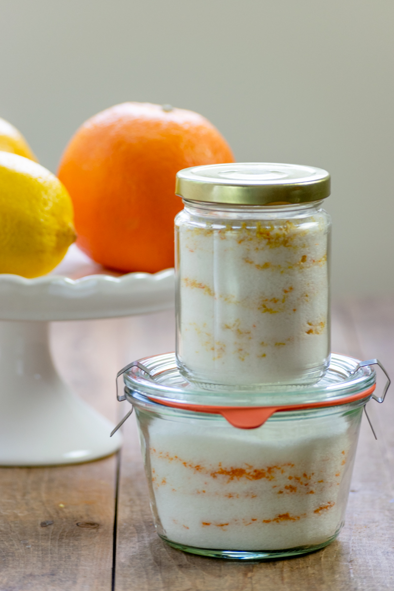 orange and lemon sugar infusing in jars