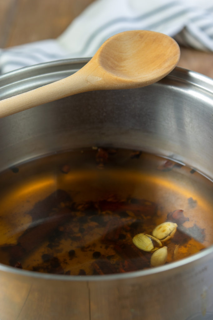 simmering cinnamon, cardamom, black pepper, star anise, cloves and ginger