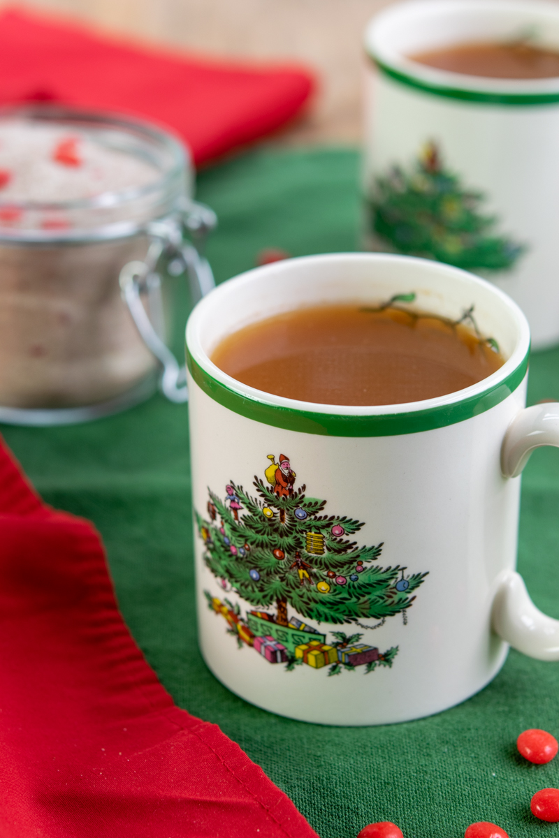 hot cup of christmas spiced tea with red hots
