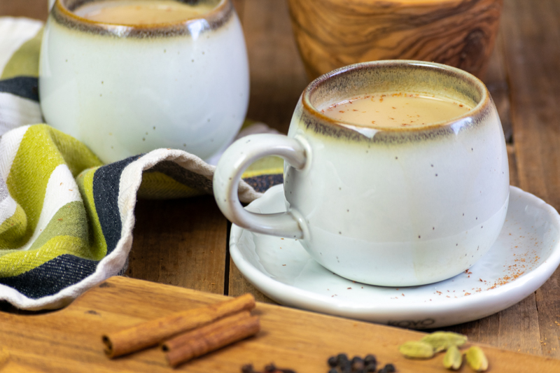 cups of masala chai with cinnamon on top