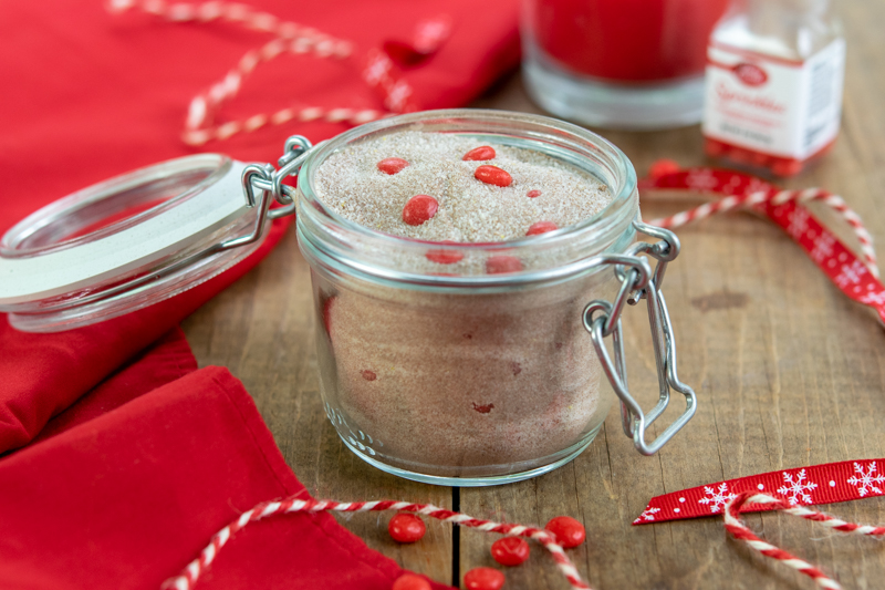 gift jar full of christmas spiced tea mix with red hots