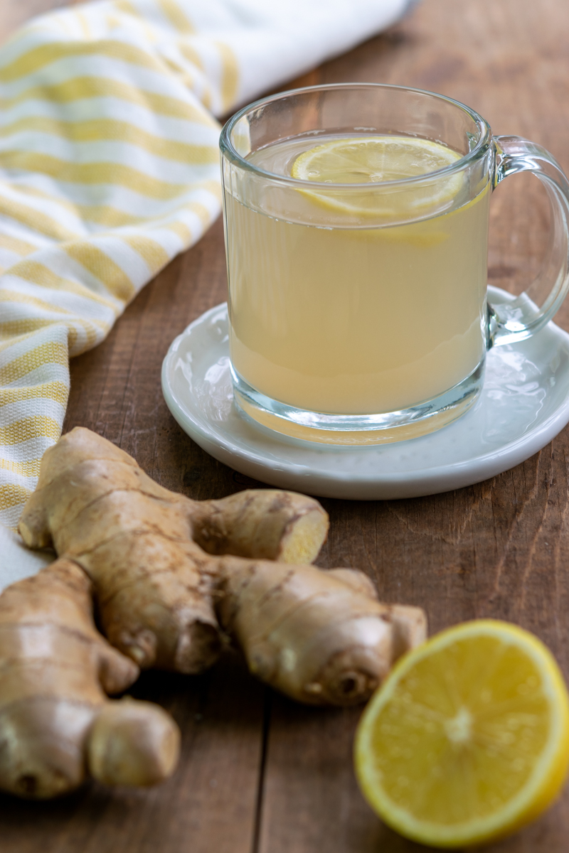 cup of fresh ginger tea, ginger root and lemon