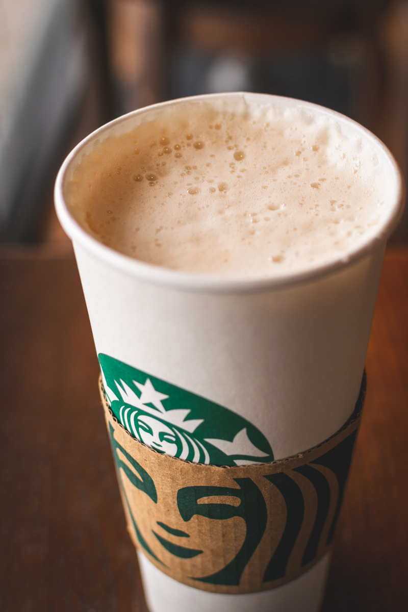 hot chai latte in starbucks cup with sleeve