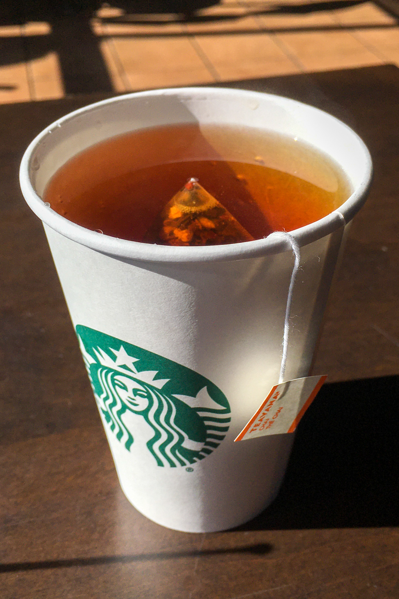 cup of starbucks hot tea with organic chai tea bag