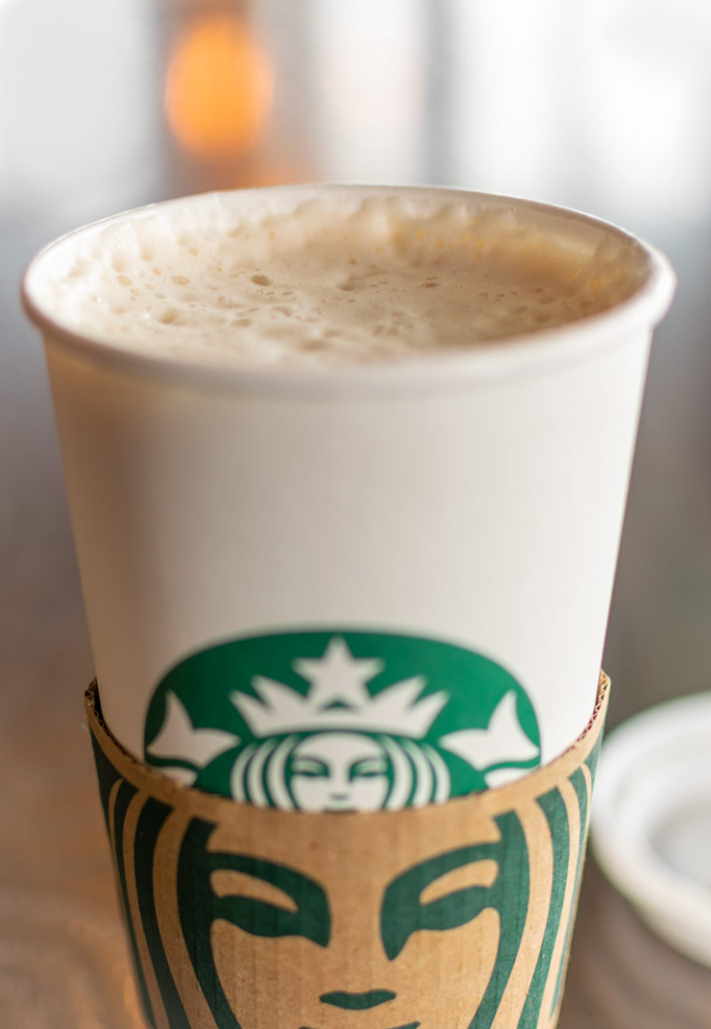 hot chai tea latte in a white starbucks cup