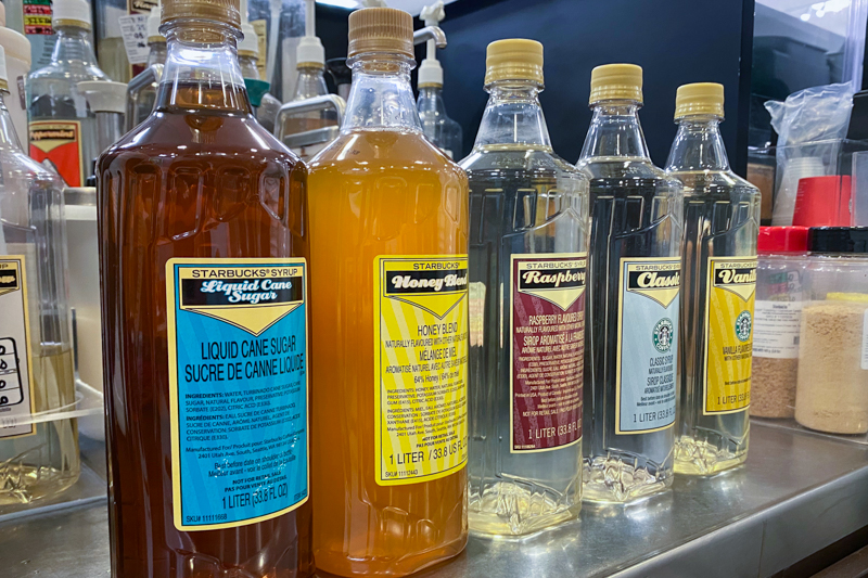 starbucks bottles of syrup lined up on counter