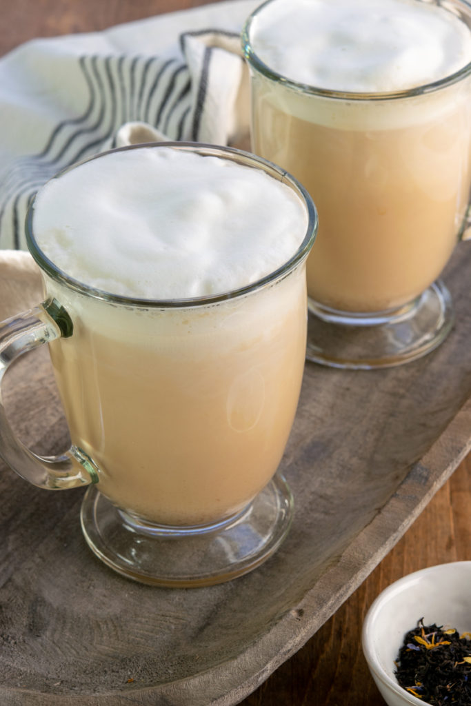 two hot tea lattes in glass mugs