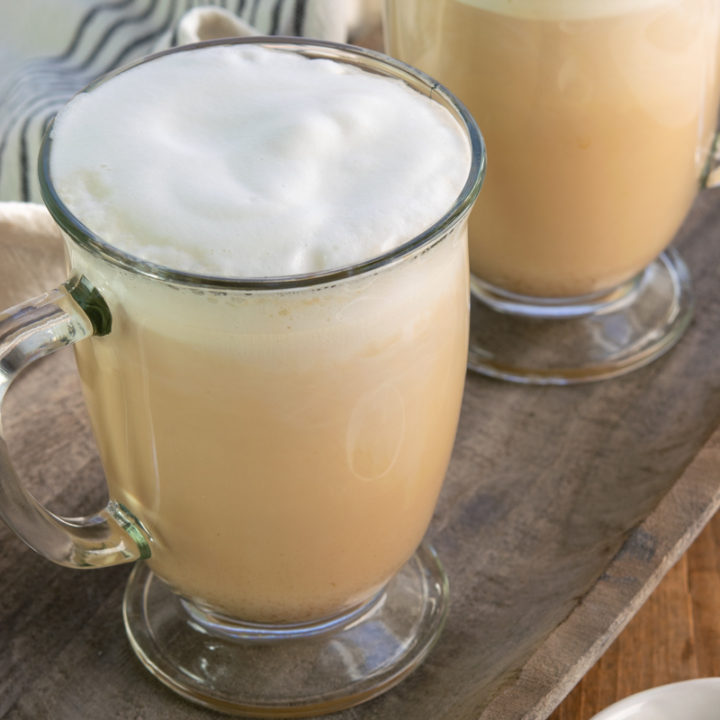 two hot tea lattes in glass mugs