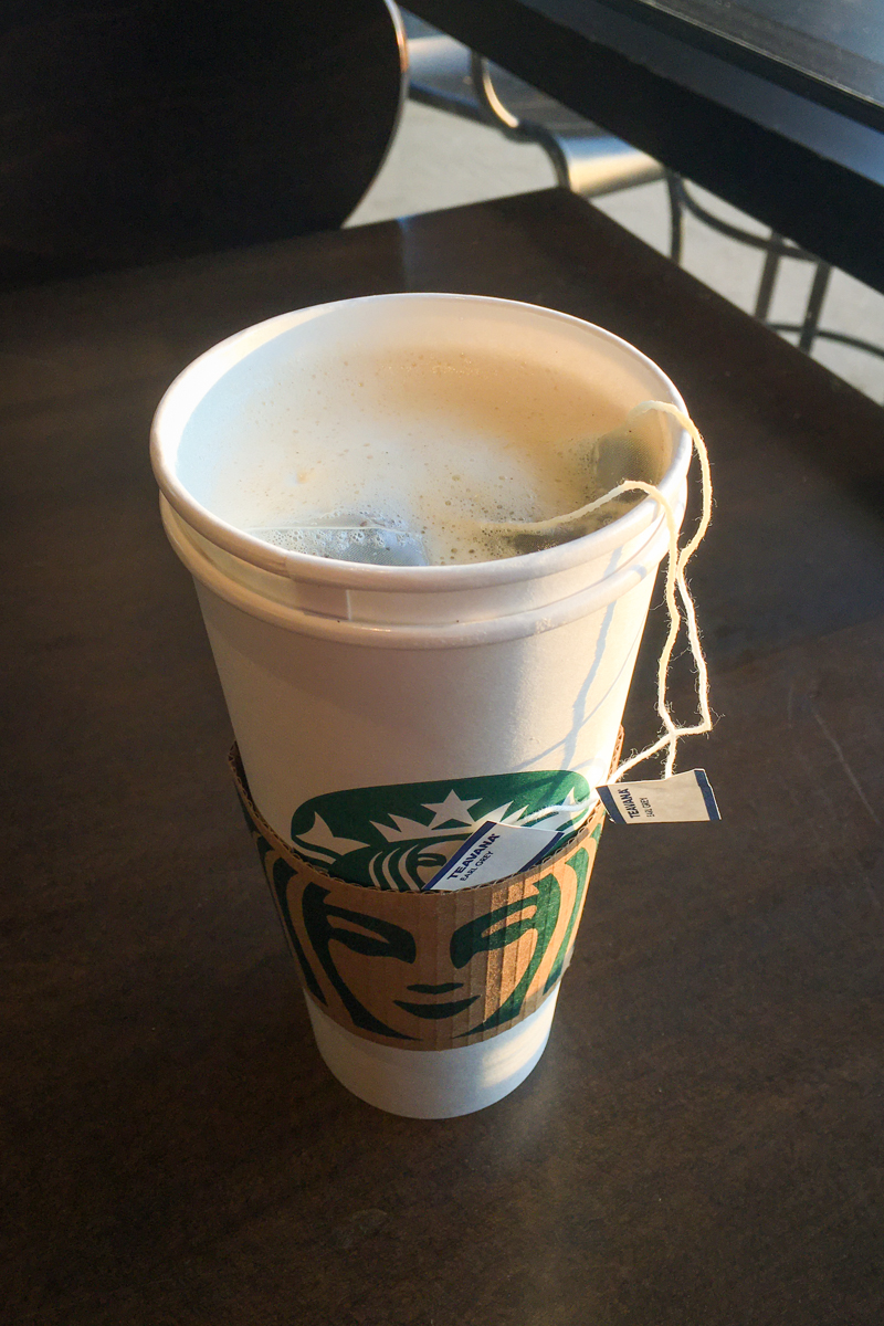 starbucks london fog tea latte in cup with lid open