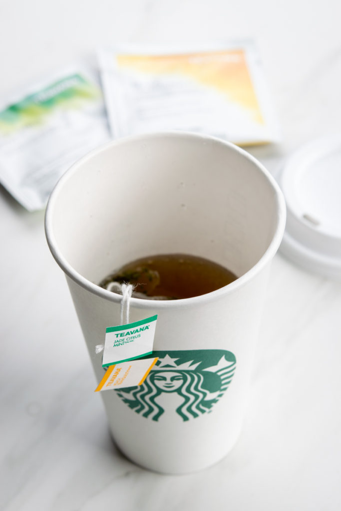 Cup of Starbucks medicine ball tea made by barista.