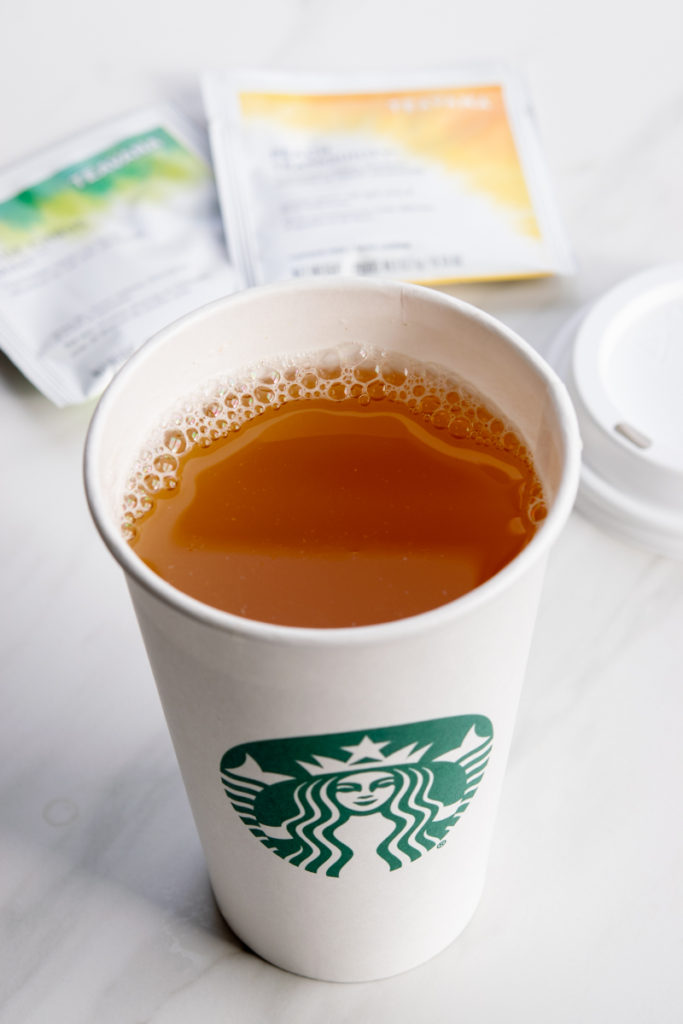 Starbucks Honey Citrus Mint tea in cup with lid off.