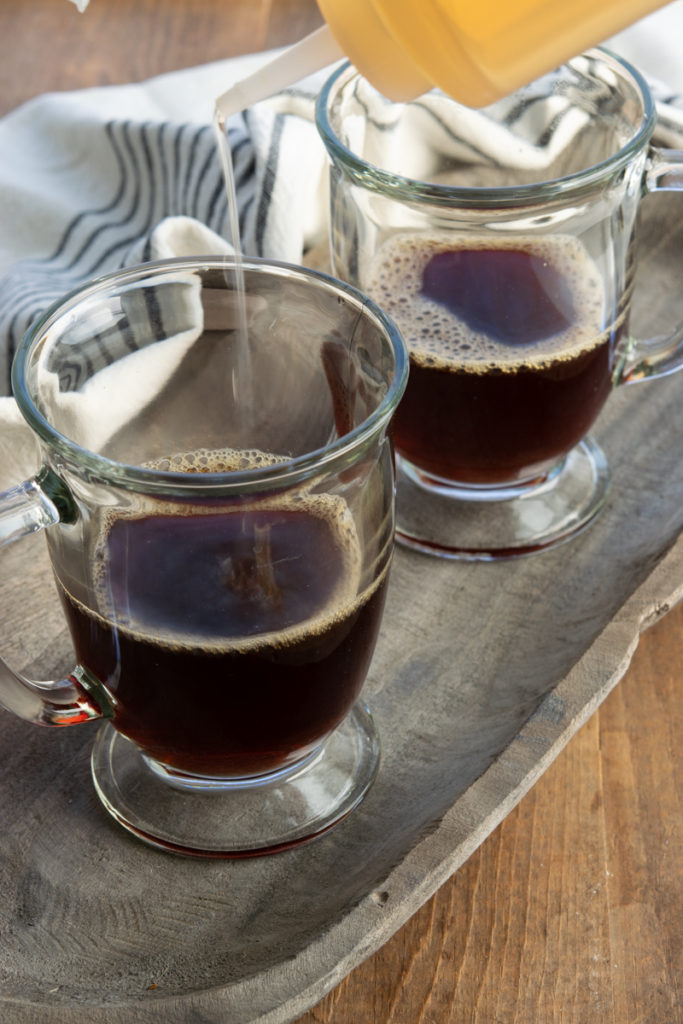 making a tea latte with strong tea in mug