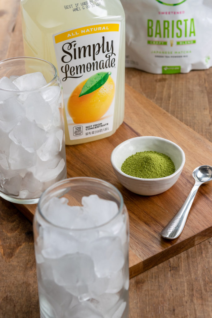 lemonade, matcha powder and two cups filled with ice cubes