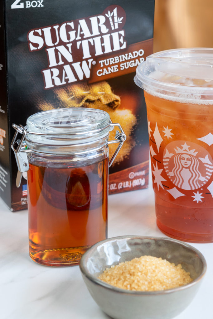 box of turbinado cane sugar, bottle of liquid cane syrup and cup of starbucks iced tea