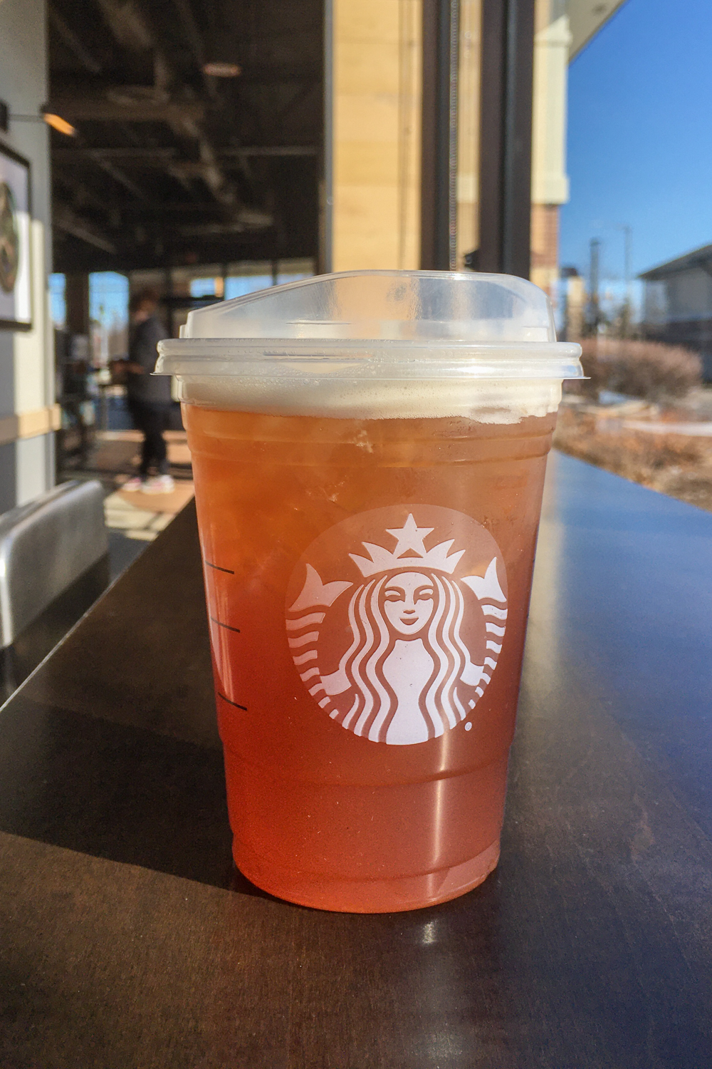 Starbucks black tea on table inside Starbucks.