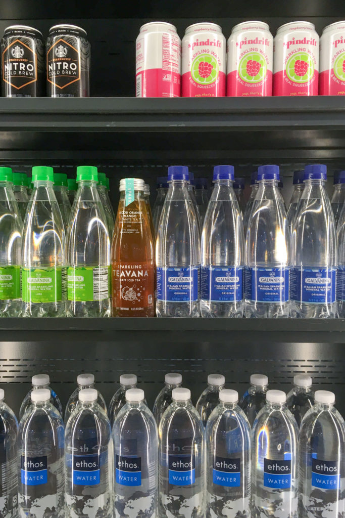 Cans and bottles of sugar-free drinks at Starbucks in cooler.