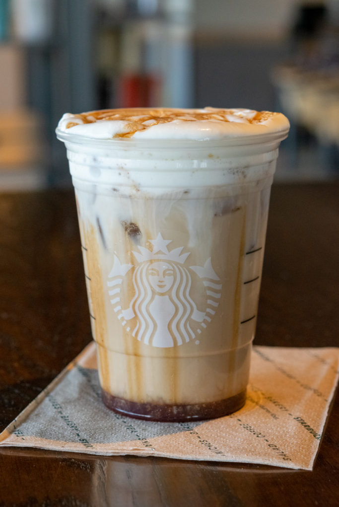 Starbucks Iced Chai Tea Latte with vanilla sweet cream cold foam and spiced apple drizzle on top.