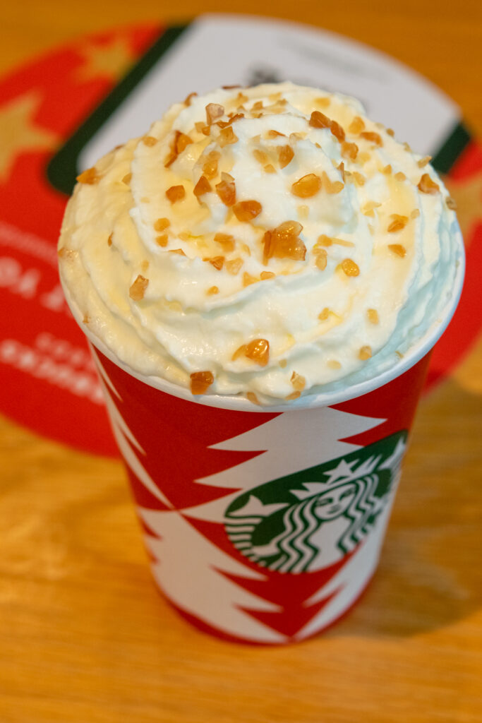 Top view of a caramel brulee creme steamer showing the whipped cream and the sugary creme brulee topping.