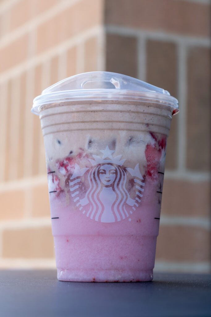 Pink Drink with a layer of real strawberries and a topping of chocolate cold foam,