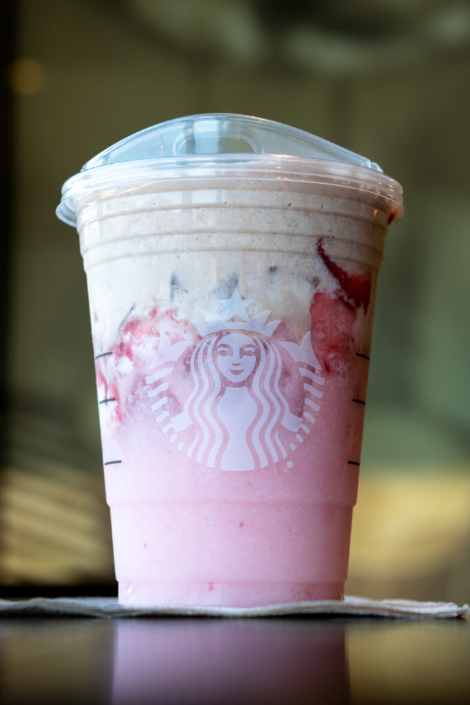 A Starbucks Pink Drink with real strawberries and covered in chocolate foam.