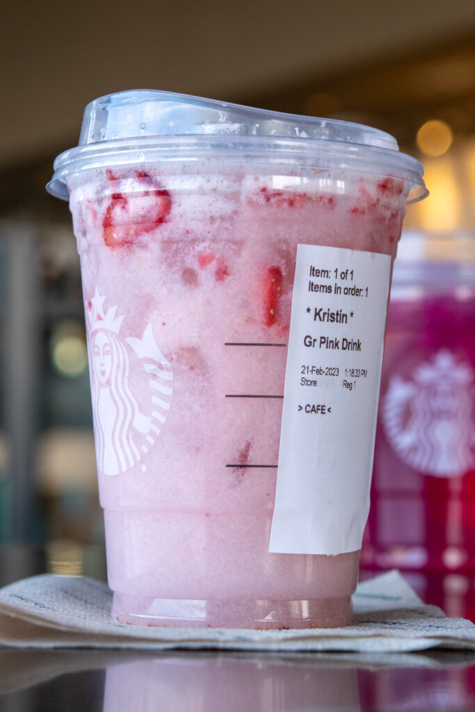 A Starbucks Pink Drink with strawberries and the order sticker showing.