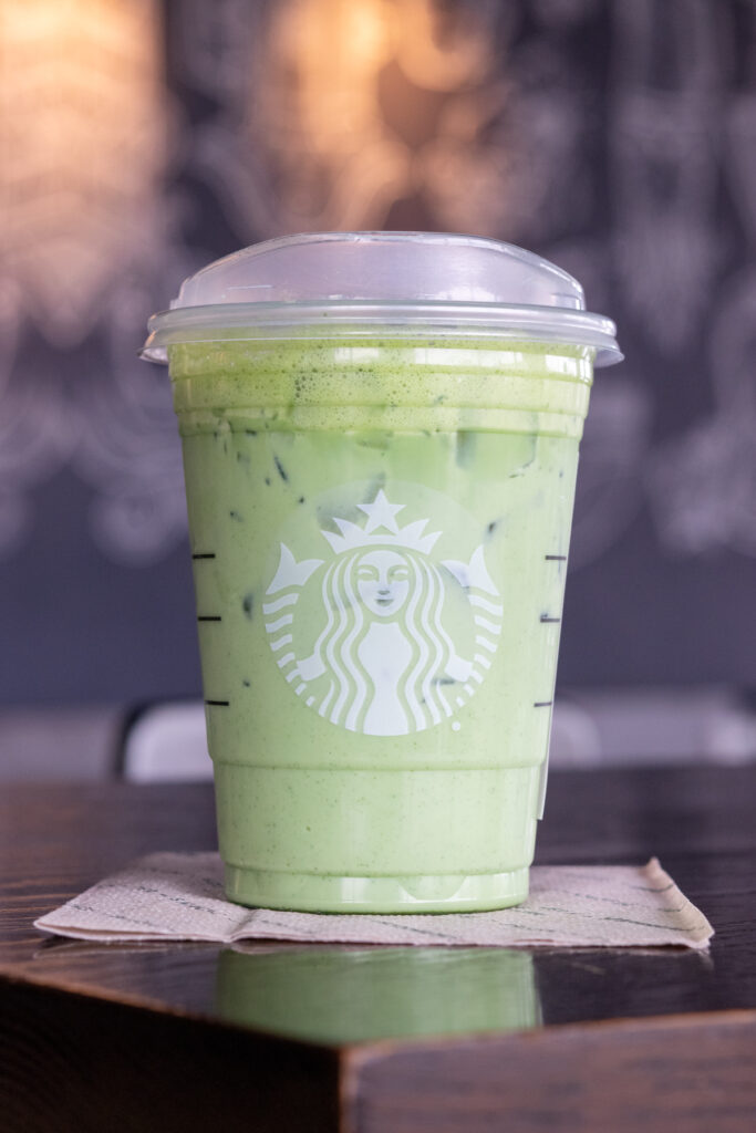 A Starbucks iced matcha latte sitting on a Starbucks napkin.