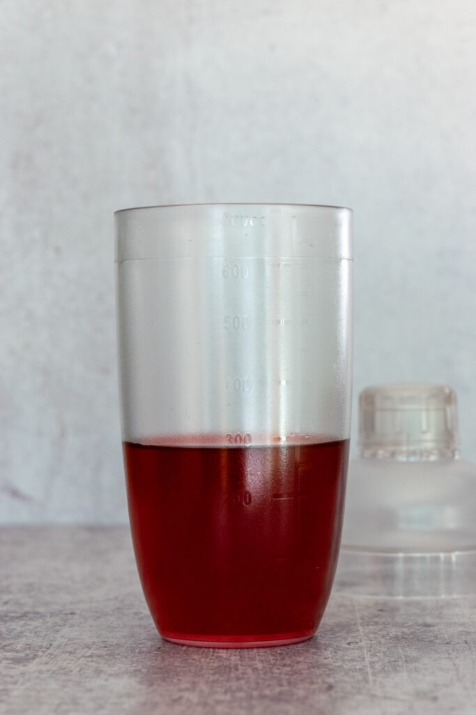 Passion tea in a drink shaker to make a keto-friendly pink drink.