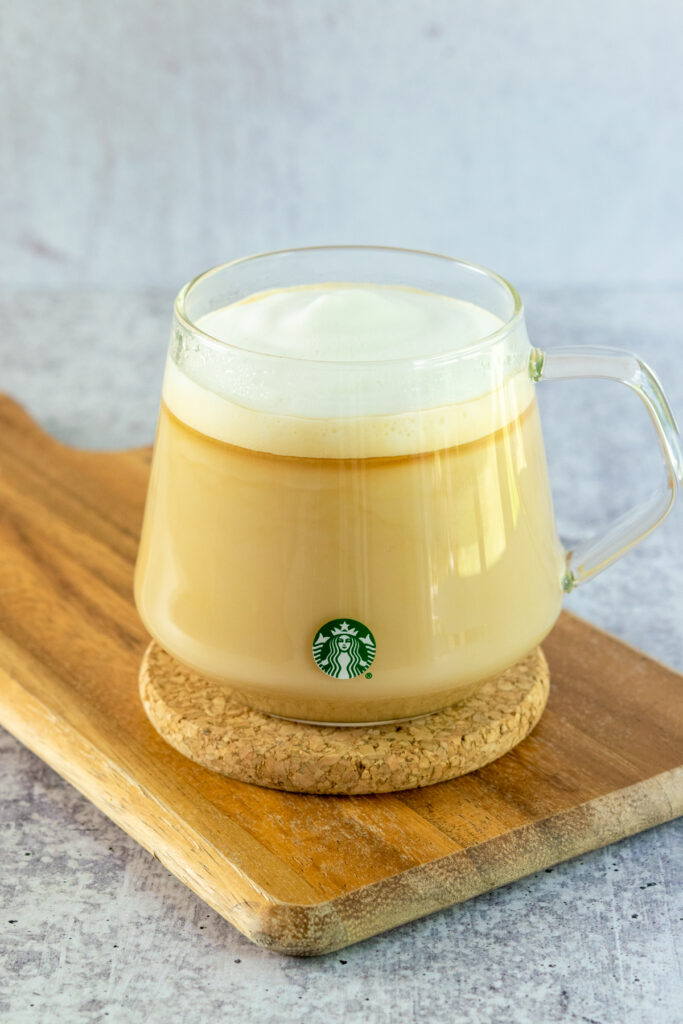 Homemade London Fog tea latte in a glass Starbucks mug.