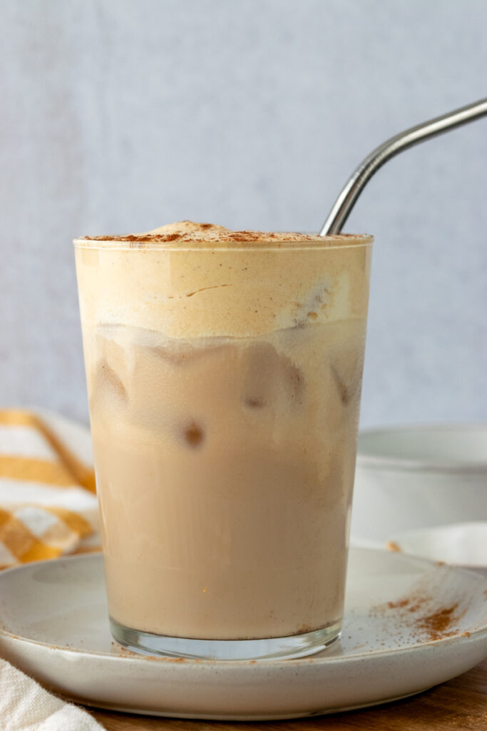 Sideview of a homemade iced chai tea latte showing how the pumpkin cold foam topping is the perfect