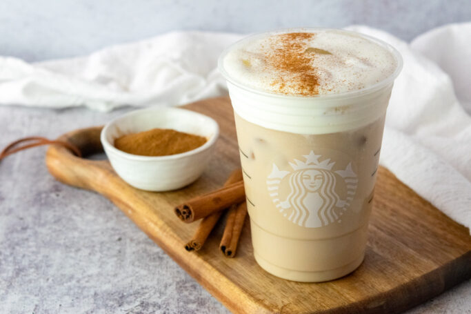 A homemade iced chai tea latte with vanilla cold foam on top in a Starbucks cup.