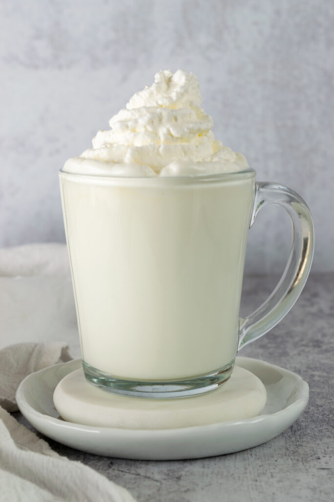 A homemade vanilla steamer with a topping of whipped cream.