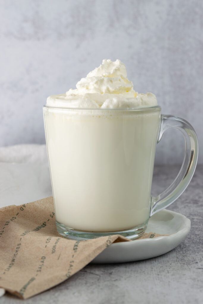 A vanilla steamer drink sitting on top of a Starbucks napkin.