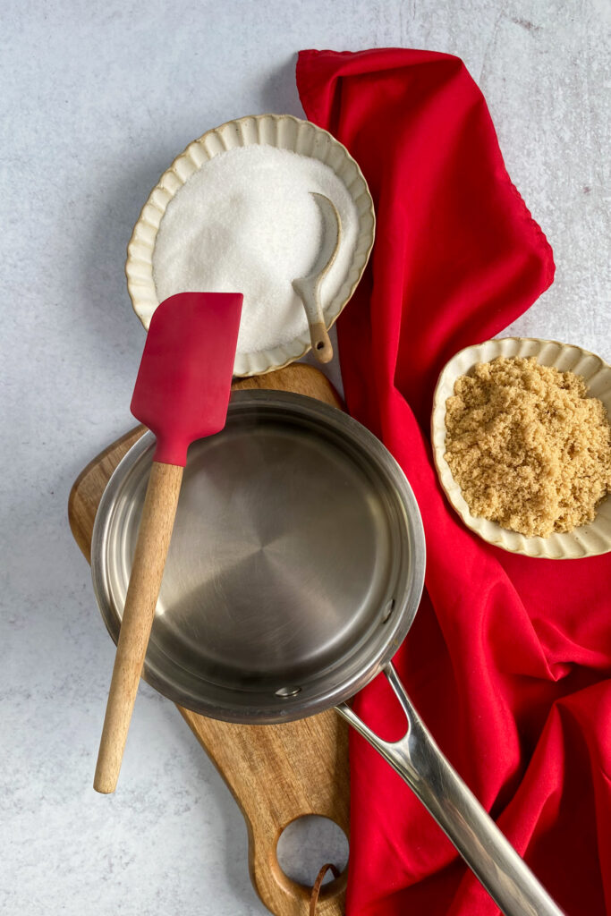 Making homemade sugar cookie syrup in a saucepan.