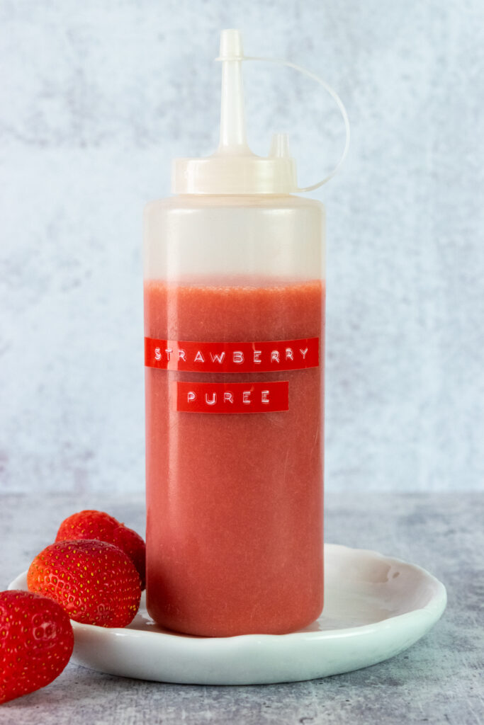Bottle of homemade strawberry puree for drinks.