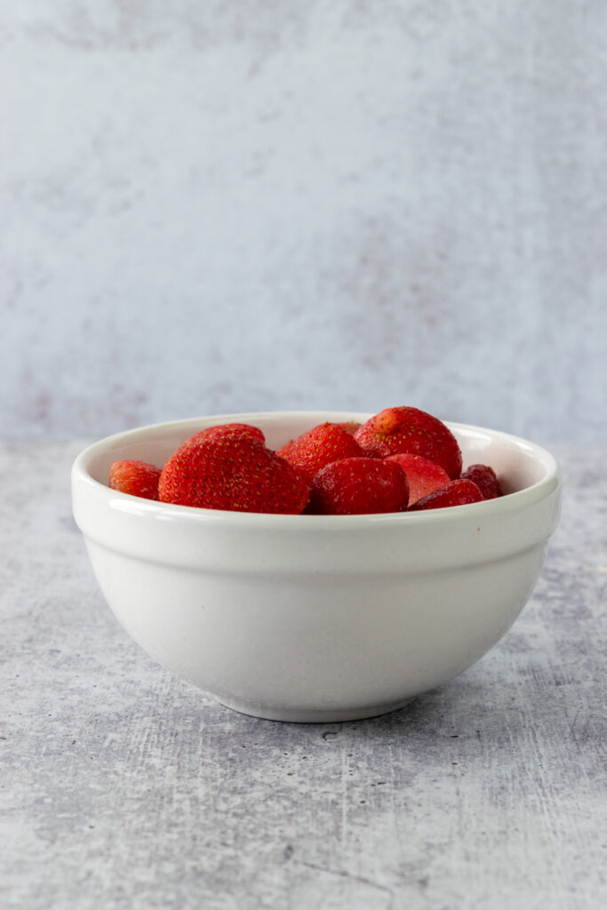 Bowl of frozen strawberries that have been thawed.