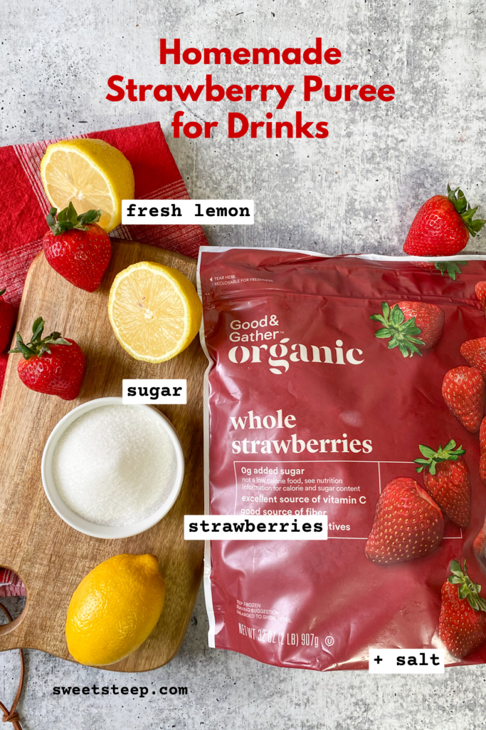 Ingredients to make strawberry puree, including a bag of frozen whole strawberries, bowl of sugar, a lemon cut in half and a few fresh strawberries.