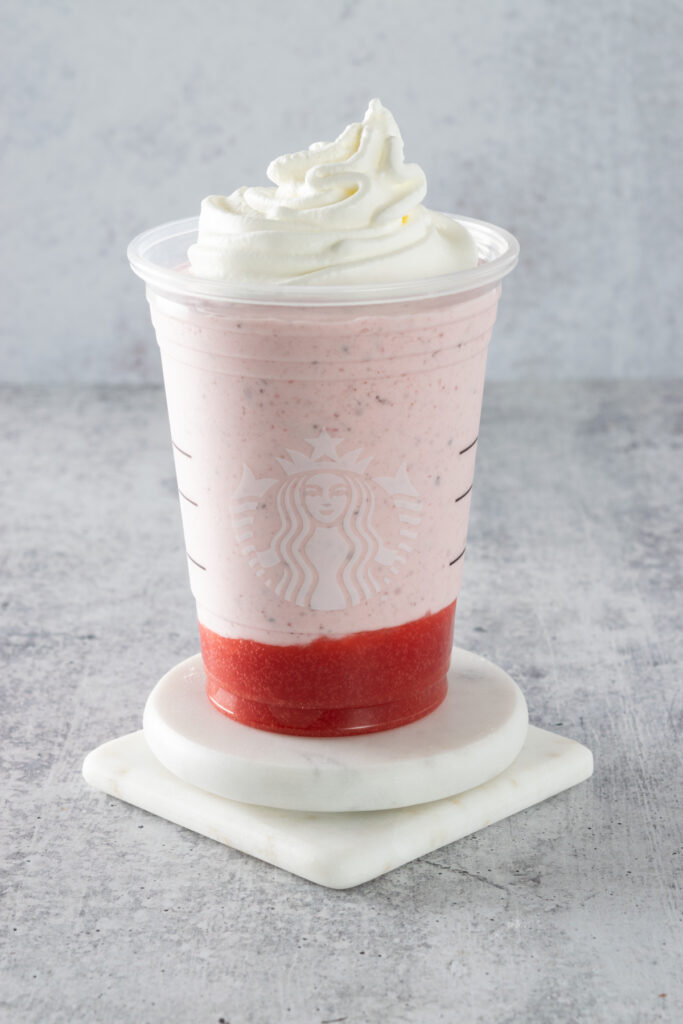 Homemade chocolate covered strawberry frappuccino topped with whipped cream.