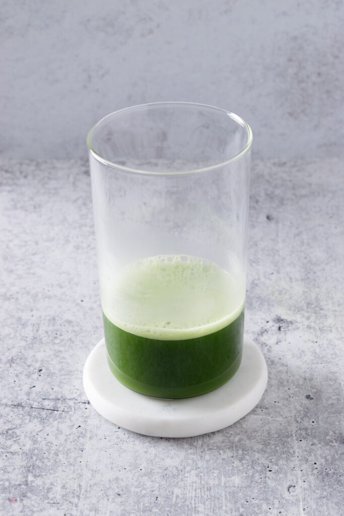 Matcha green tea poured into a tall drinking glass.
