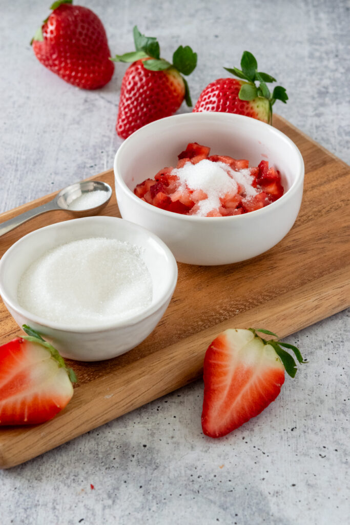 Diced strawberries in a small bowl with sugar on top.