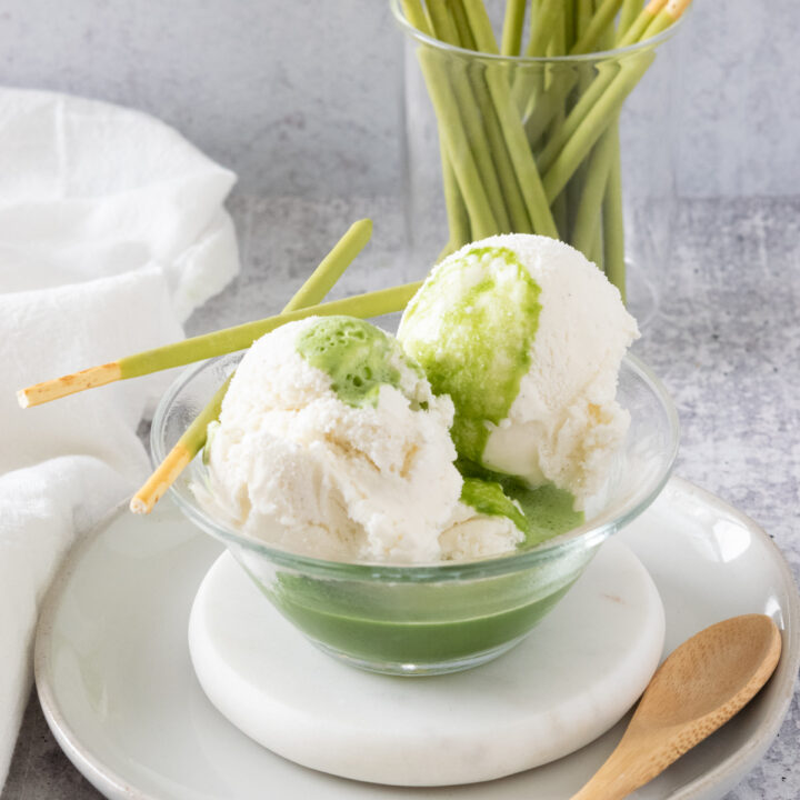 Matcha Affogato with vanilla ice cream in a small bowl with matcha green tea poured over it.